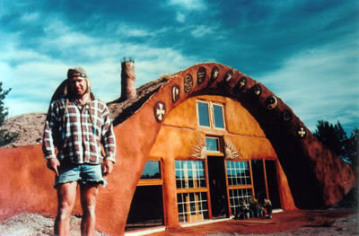 Cody stands outside his finished home near Prescott, Az.